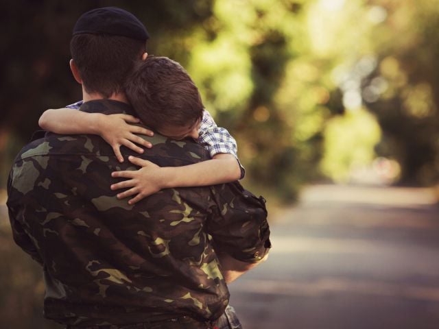 Solider hugging child